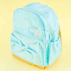 This sky-blue backpack has cute prints of Cinnamoroll, bows, and cherries! It’s also decorated with a huge ribbon attached to the front pocket. Bring this cute bag with you on your next trip! Features a double zipper closure Medium size on the tag Comes with a zippered front pocket, 2 side pockets, 1 inner pocket, and Adjustable Bag Strap, Cute Prints, Adjustable Bag, Kawaii Shop, Blue Backpack, Cute Bag, Bag Straps, Front Pocket, Medium Size