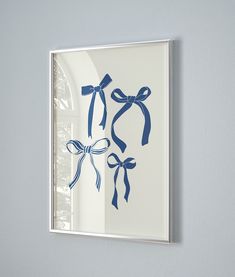 a blue and white bow is hanging on the wall in front of a window,