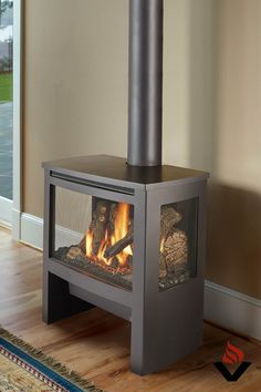 a fire place sitting on top of a hard wood floor next to a door and window