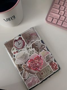 a desk with a keyboard, mouse and stickers on it