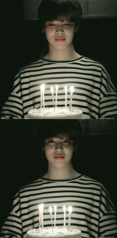 a person holding a cake with lit candles in front of their face and the words happy birthday on it