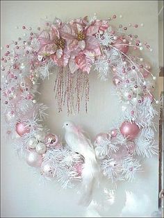 a pink perfume bottle next to an image of a wreath with flowers and pearls on it