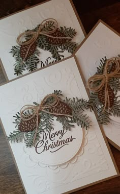 three christmas cards with pine cones and bows