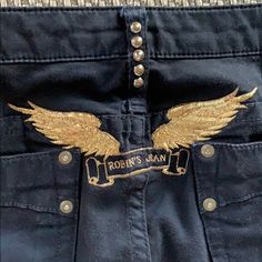 Black Super Soft Stretch Straight Leg Jeans. Vibrant Gold Metallic Thread Stitched Angel Wings On Back And Front Watch Pocket. Brass Studs On Pockets And Back Belt Loop. Preowned. Excellent Condition. 97% Cotton 3% Lycra 33” Inseam Angel Wings On Back, Wings On Back, Robin Jeans, Watch Pocket, Stitch And Angel, Leg Stretching, Metallic Thread, Stretch Jeans, Angel Wings