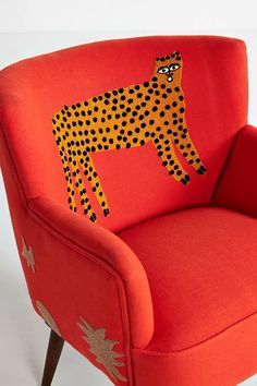 an orange chair with a cheetah painted on it