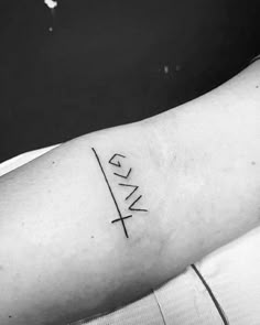 a black and white photo of a person's arm with the word love on it