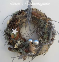 a wreath with silver balls and pine cones