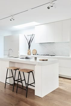 two stools are in front of the kitchen island