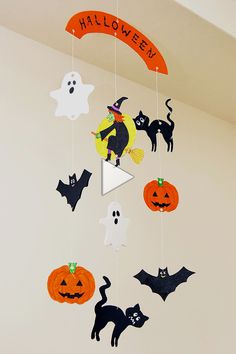 a mobile with halloween decorations hanging from it