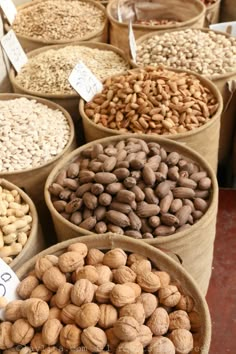 several baskets filled with nuts on display for sale