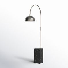 a floor lamp with a marble block base and a metal light shade on the top