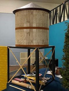 a tall wooden tower sitting on top of a blue carpet