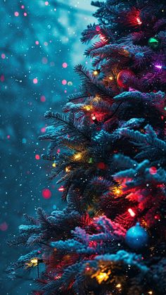 a christmas tree is lit up with colorful lights and snow falling down on the ground