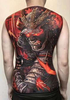 the back of a man's shirt with tattoos on his body and an image of a samurai