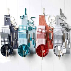 colorful kitchen towels and utensils hanging from hooks