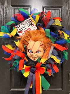 a halloween wreath with a creepy clown head on the front door for someone's house