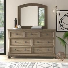 a bedroom with a dresser and mirror in it