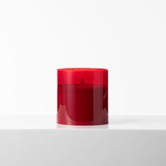 a red cup sitting on top of a white table