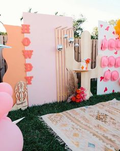 an outdoor party with balloons and decorations