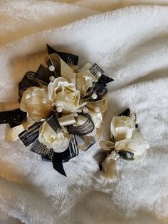 two white and black flowers on a white blanket with gold sequins in the center