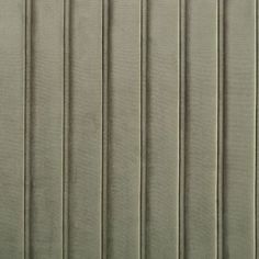 an upholstered wall with vertical blinds on it