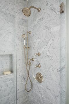 the shower head and handset are connected to the faucet in this bathroom