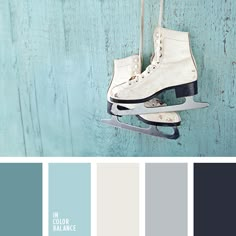 a pair of ice skates hanging on a wall with color swatches in the background