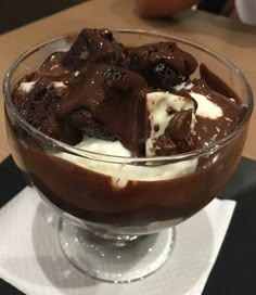 a dessert dish with ice cream, chocolate and marshmallows in it on a table