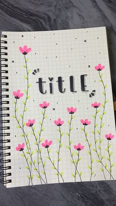 a notebook with the word tulle written on it and pink flowers in the middle