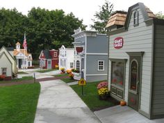 a small town with lots of houses on the street and flowers in front of it