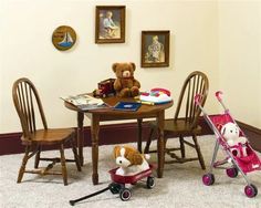 a teddy bear sitting on top of a chair next to a table with three chairs