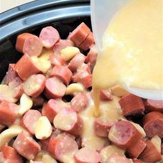 the food is being poured into the slow cooker to make it look like it has been cooked