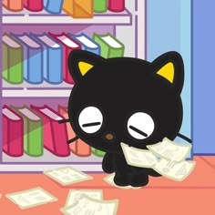 a black cat sitting on top of a table next to stacks of papers