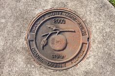 a manhole cover with an orange on it