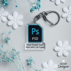 a metal keychain with the word psd printed on it next to snowflakes