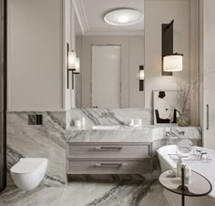 a bathroom with marble counter tops and white fixtures, along with a tub in the middle