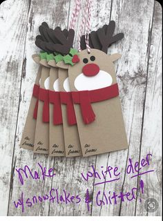 four christmas cards hanging from a string on a wooden table