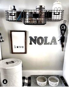 a bathroom with black and white checkered flooring, toilet paper dispensers and baskets on the wall