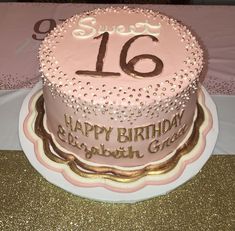 a pink and gold birthday cake with the number sixteen on it