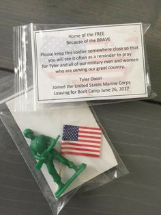 a small plastic toy soldier with an american flag on it's lap, in a clear package