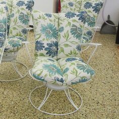 four chairs with blue and green flowers on them