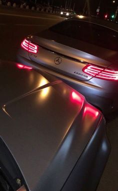 a car that is sitting on the side of the road with its brake lights on