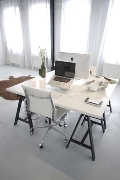 a white desk topped with a laptop computer