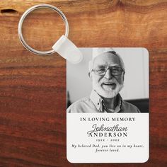 an old man's photo is attached to a keychain that reads, in loving memory appreciation anderson