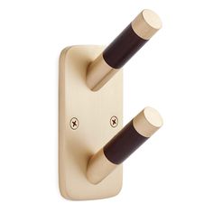 two wooden pegs are attached to the back of a light switch with black handles