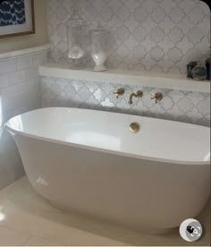 a white bath tub sitting inside of a bathroom