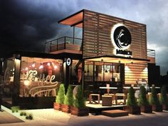 an artist's rendering of the exterior of a restaurant at night with dark clouds in the background