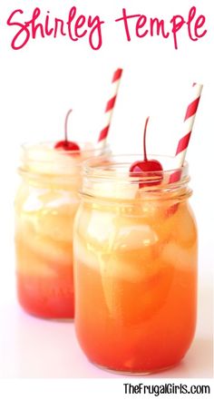 two mason jars filled with orange liquid and topped with cherries, striped straws