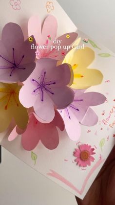 a hand holding a flower pop up card