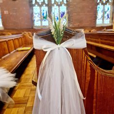 a white ribbon tied to the pews of a church